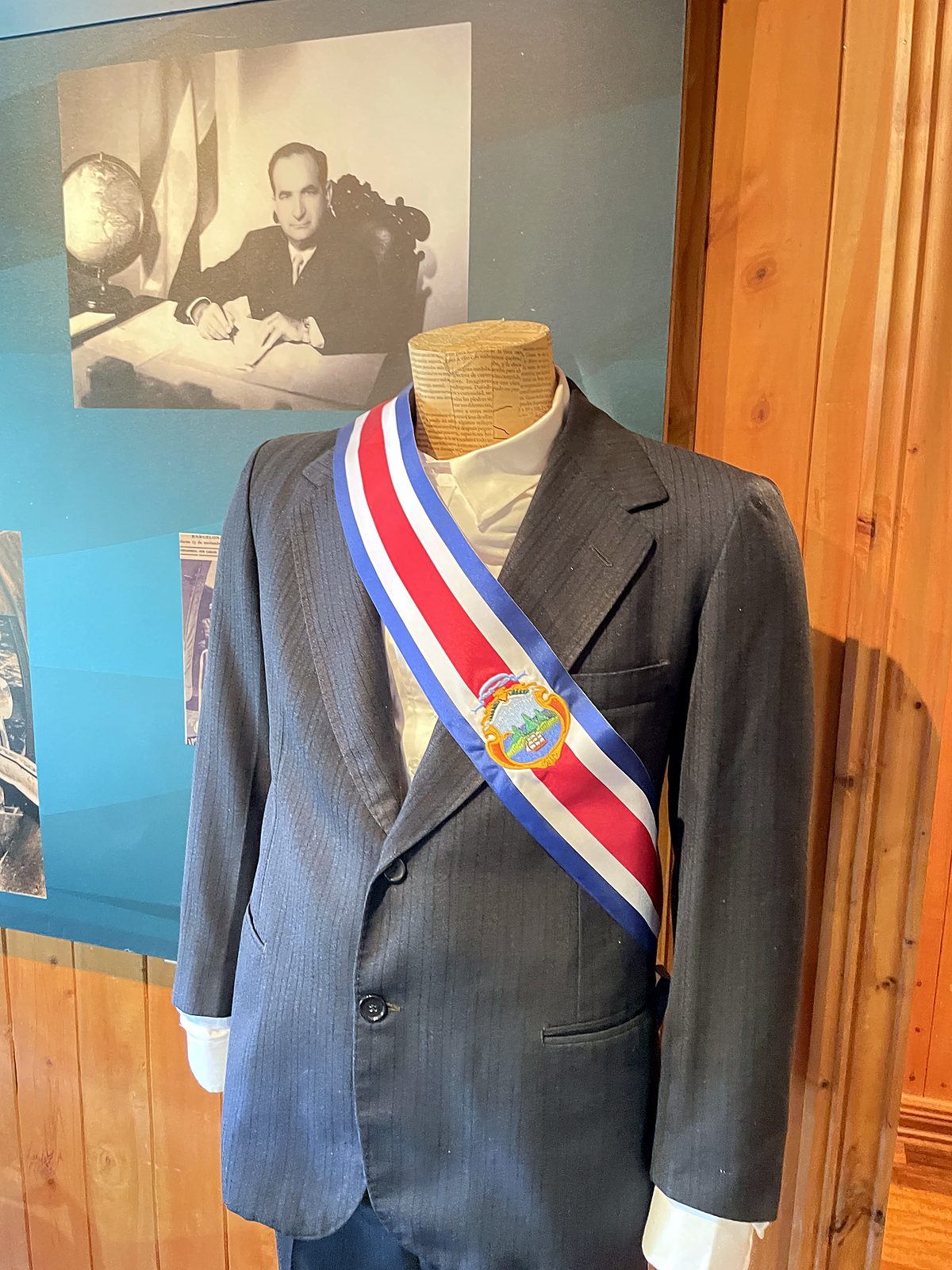 A suit with the presidential sash at Finca La Lucha