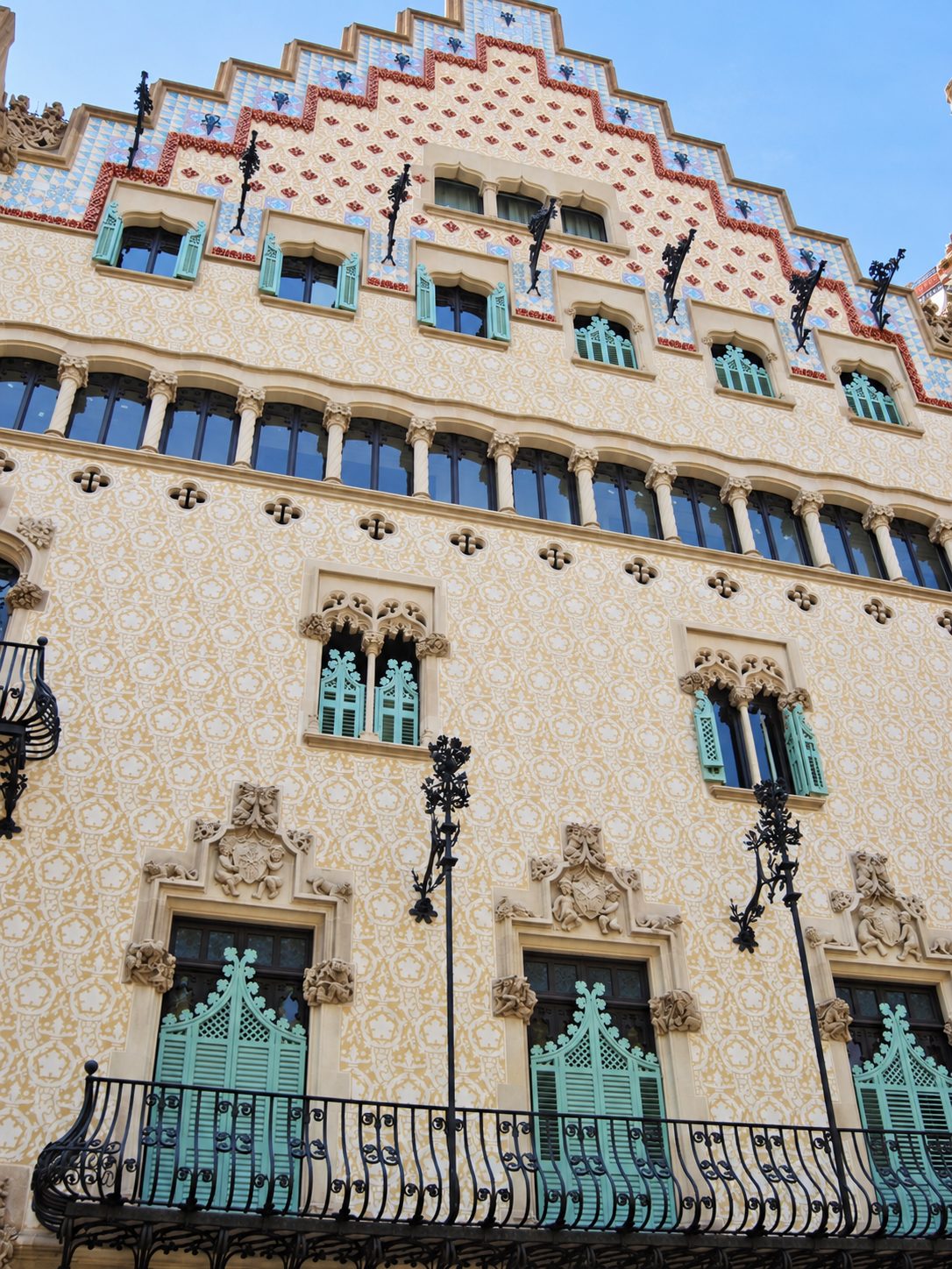 A building front with tiles and iron balconies in Barcelona