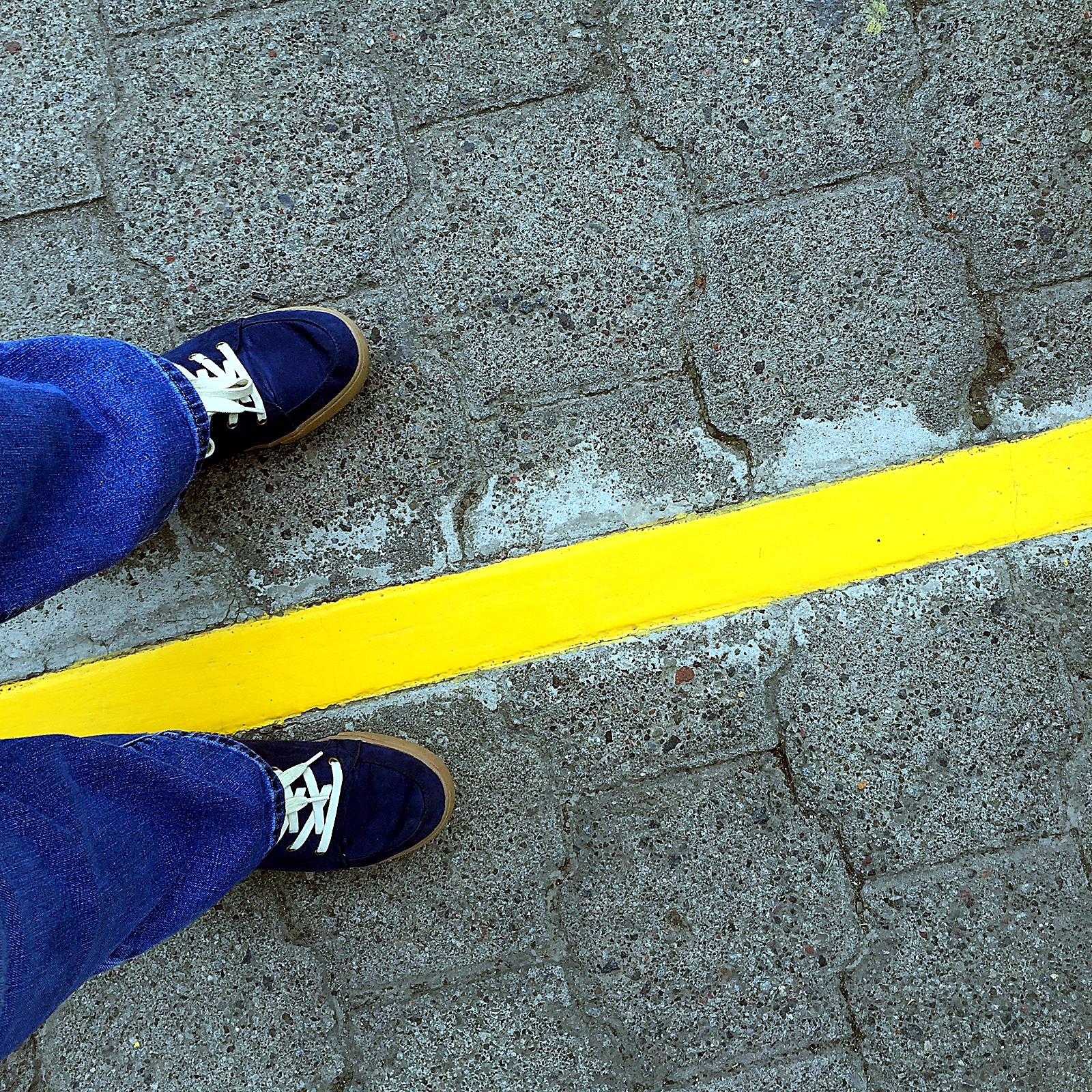 Standing with one foot on each side of the equator line