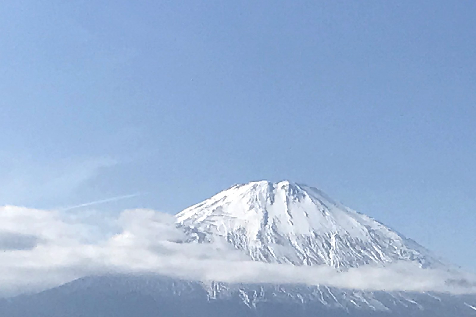 Snowy Mount Fuji above the clouds