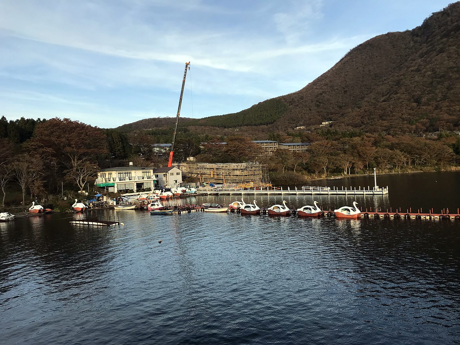 A lake with boats and green mountains in Hakone