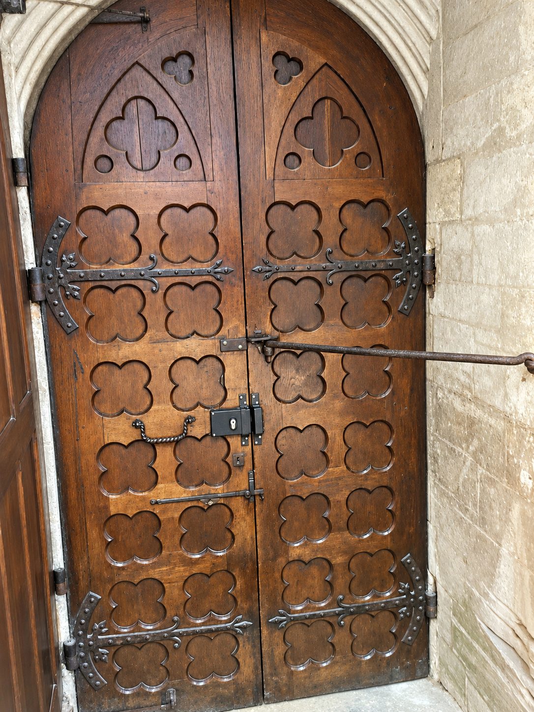 A carved wooden church door with iron hinges in Europe
