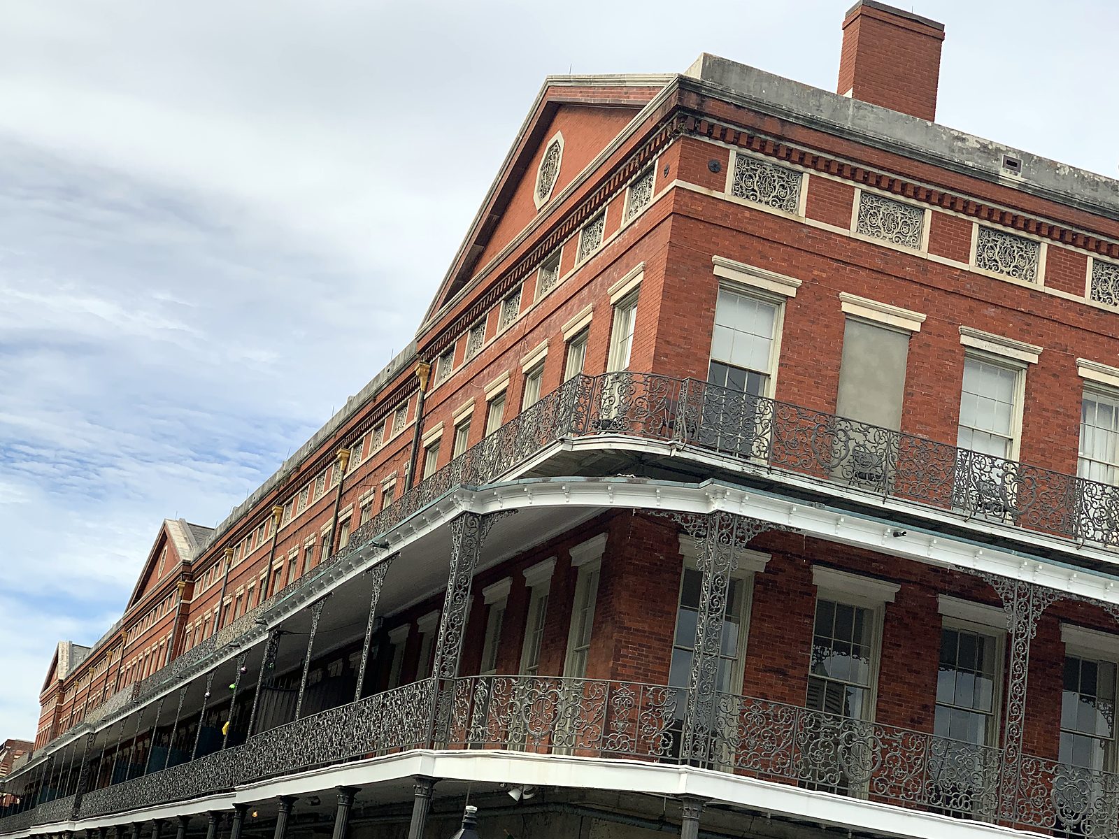 Red brick building with long iron balconies in the French Quarter