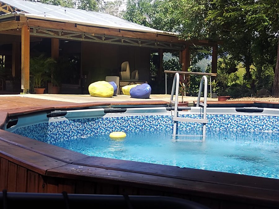 Pool next to a covered terrace