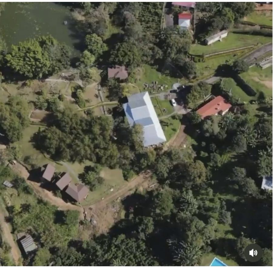 Aerial view of the property and the green land around it